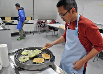 Participants preparing Okonomiyaki